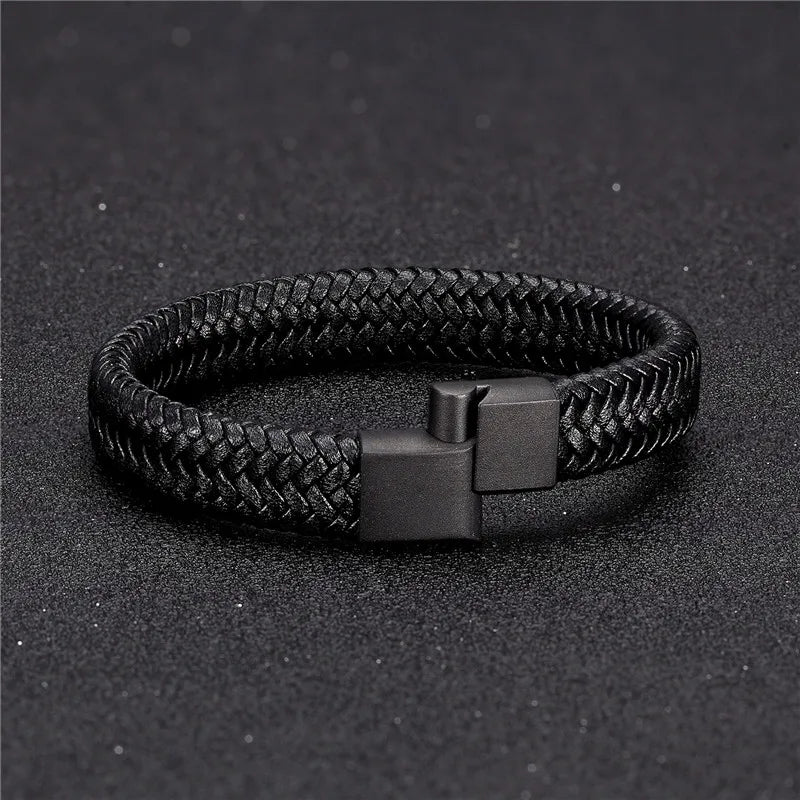 Black braided bracelet on a dark textured background