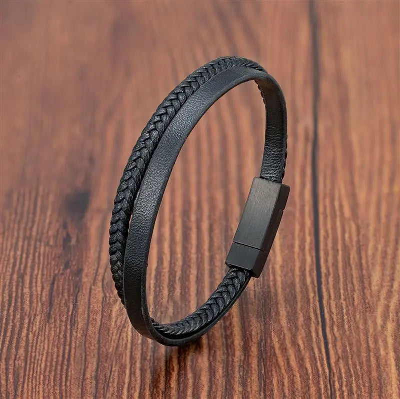 Black braided leather bracelet on a wooden surface