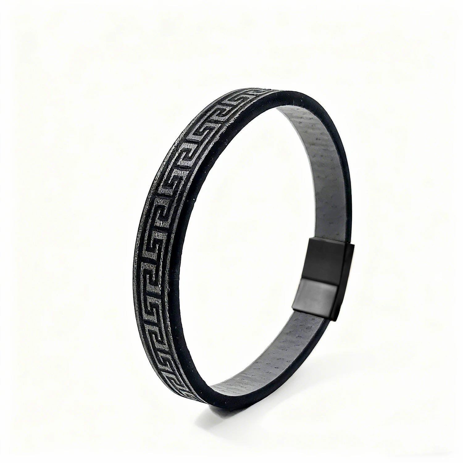 Black metal bracelet with engraved design on a white background